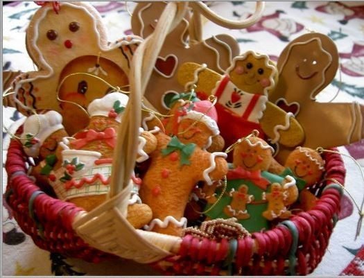 A woven basket filled with assorted gingerbread man cookies decorated with colorful icing, some dressed as bakers and others with festive holiday designs—perfect for adding a homemade touch to the holidays while saving money. - Beise Real Estate