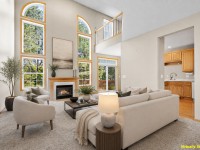 A spacious living room at 17595 Wiedman Way in Eden Prairie features tall windows, a fireplace, neutral furniture, and an open view into the kitchen; note "Virtually Staged" text in the corner. - Beise Real Estate